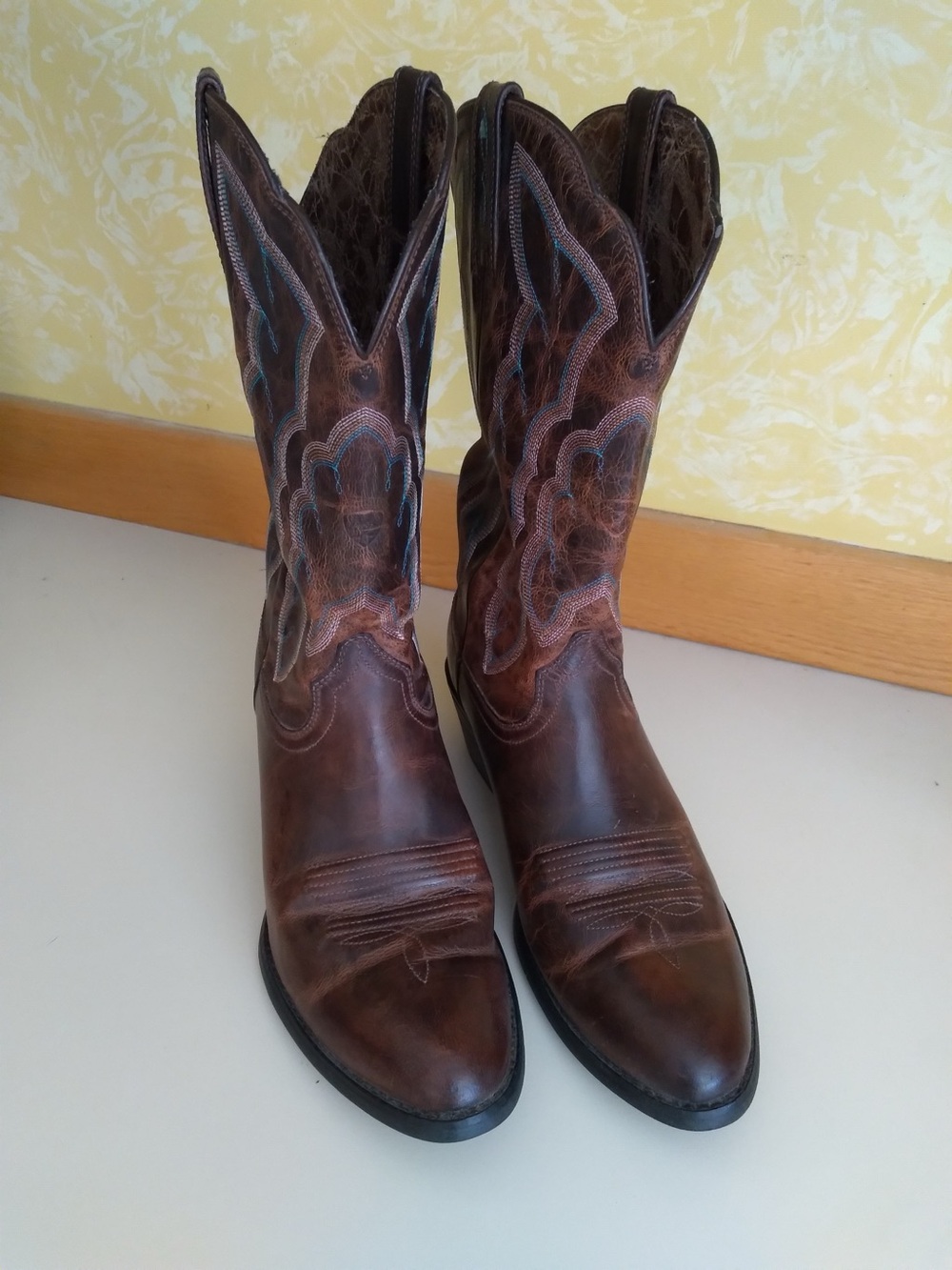 Brown leather cowboy boots with blue accent